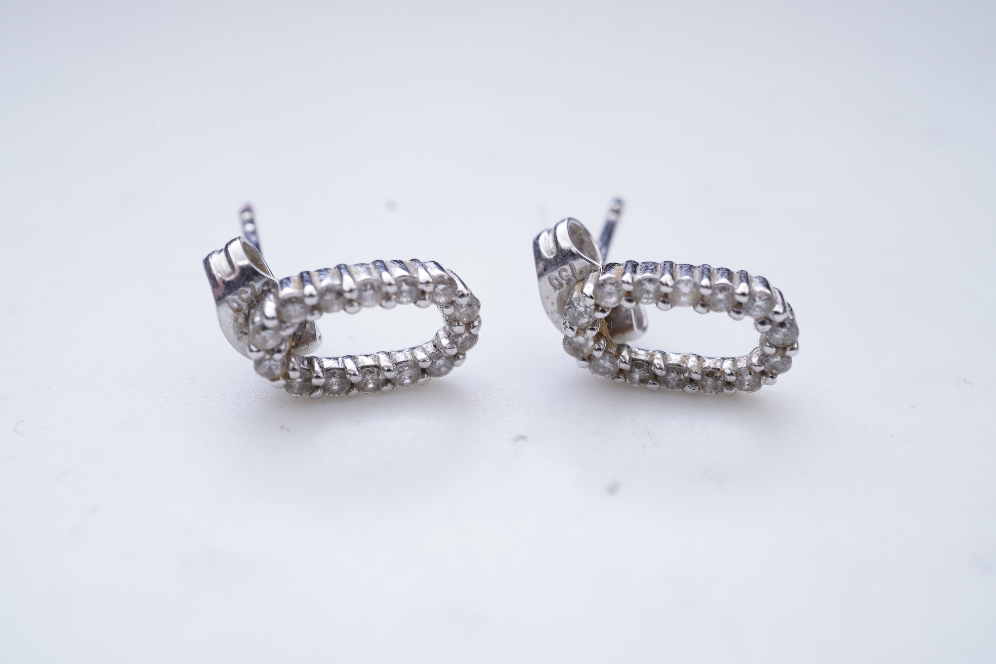 A diamond pendant and pair of diamond stud earrings